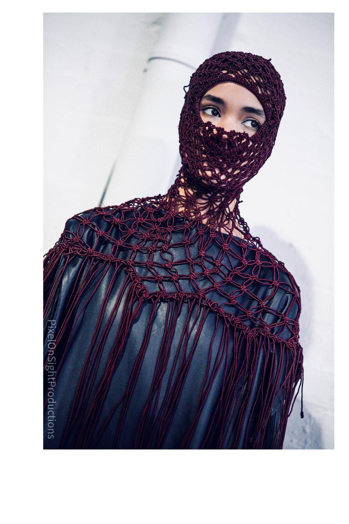 Fashion model wearing a burgundy netted look